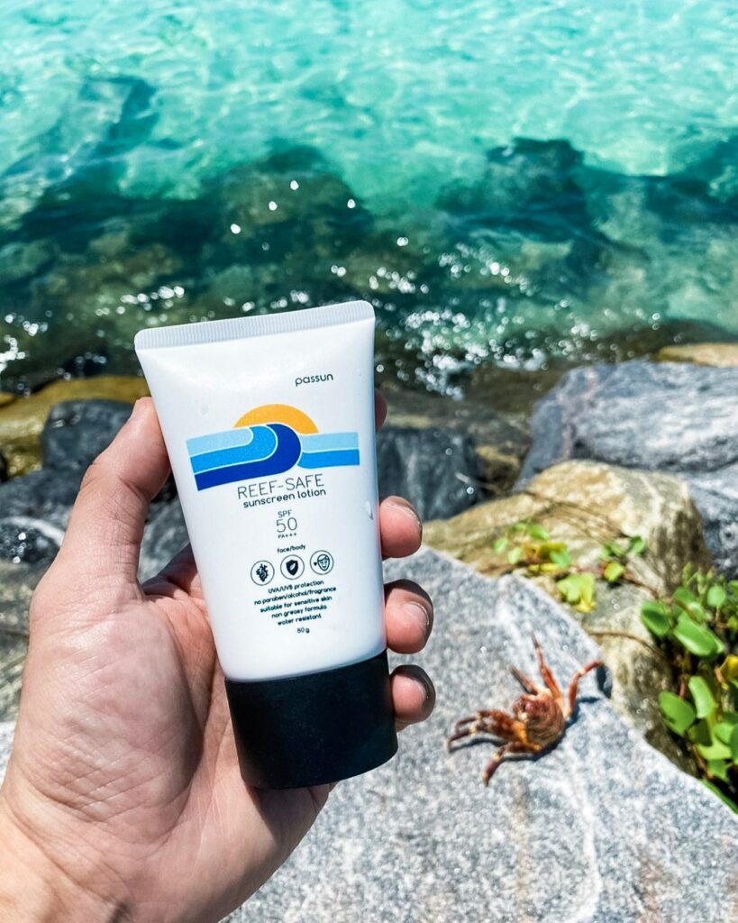 Passun Reef-Safe sunscreen by the beach with Crab